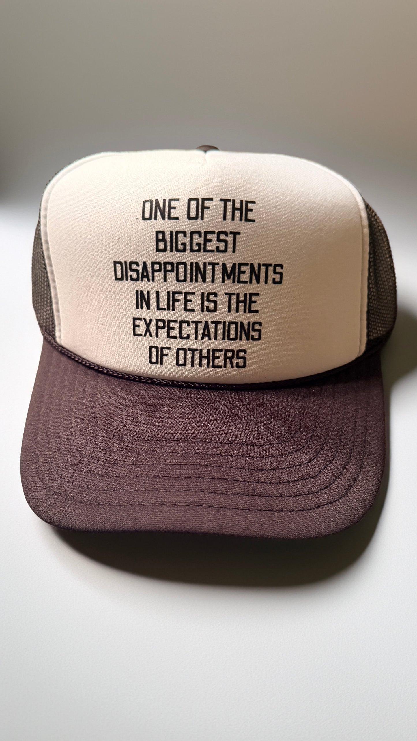 Trucker hat with motivational quote on a plain background